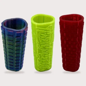 Multicolor block, neon green relief, and red textured cart handle grips standing together on a light background