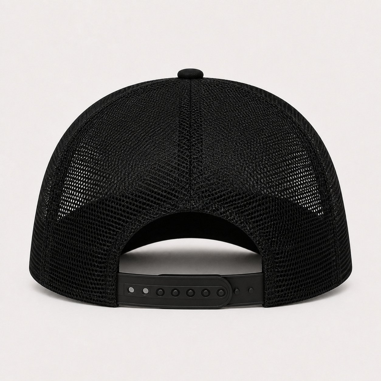 Back of black trucker hat showing plain mesh and snap closure